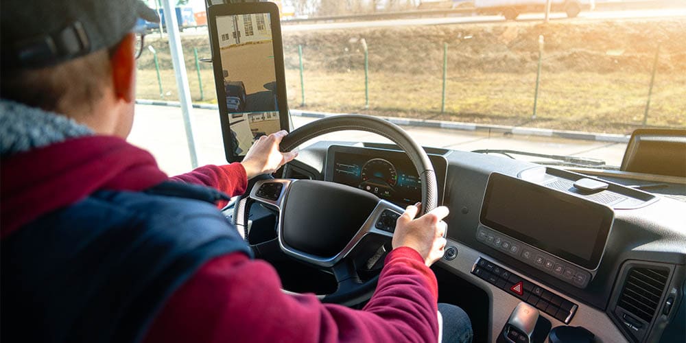 Man driving a truck with rear view camera