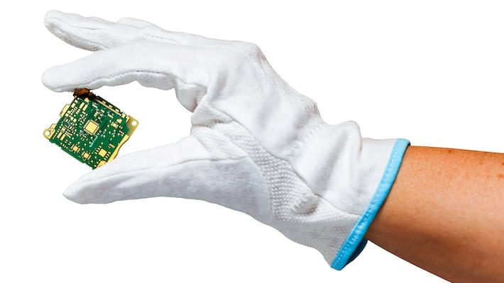 A hand holding a small PCB | NCAB Group